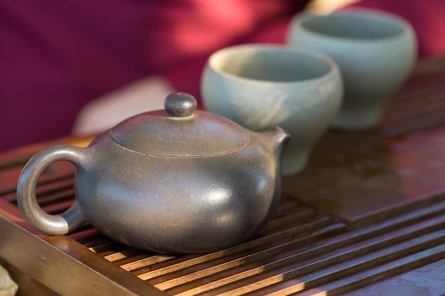 Chinese tea ceremony Ceramic teapot made of clay and bowls on a wooden background