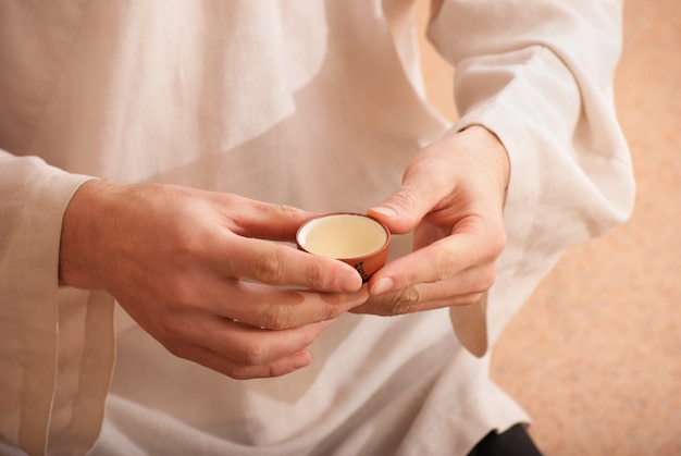 Chinese tea ceremony is perfomed by tea master in kimono