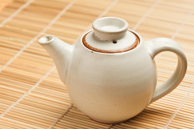 Chinese teapot on bamboo mat