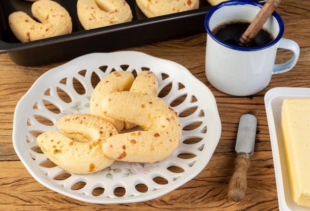 Chipas, typical south american cheese bun on a plate with butter.