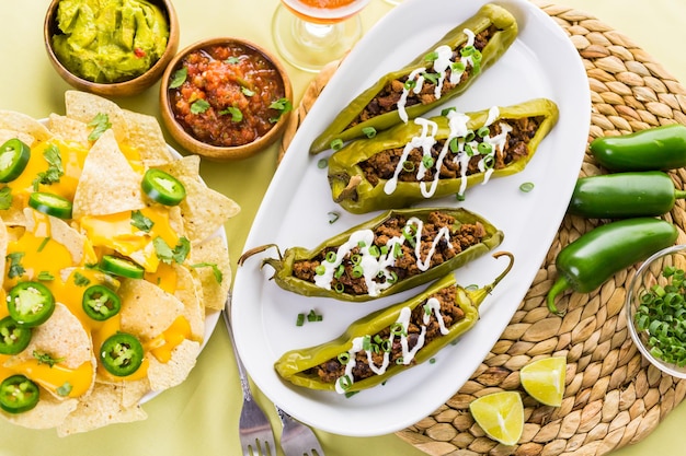 Chipotle beef & bean stuffed chili peppers garnished with sour cream and scallions.