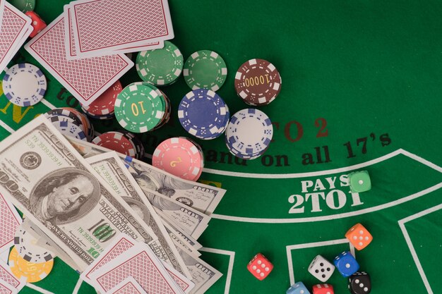 Chips and cards for poker in hand on green table