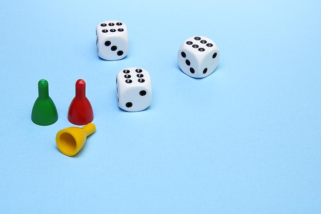 Chips and dice for the game with the same number dropped on a blue background