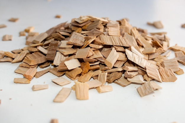 Chips for smoking meat and fish products are scattered in a pile.