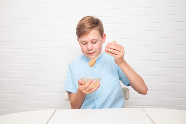 Chisinau, MOLDOVA - 29 June 2022. European teenager is tasting honey