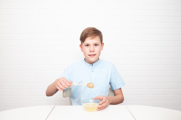 Chisinau, MOLDOVA - 29 June 2022. European teenager is tasting honey