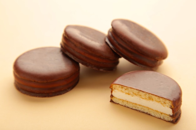 Choco pie chocolate coated snacks on beige background. Top view