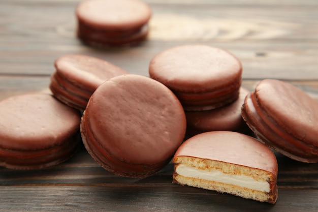 Choco pie chocolate coated snacks on brown background. Top view