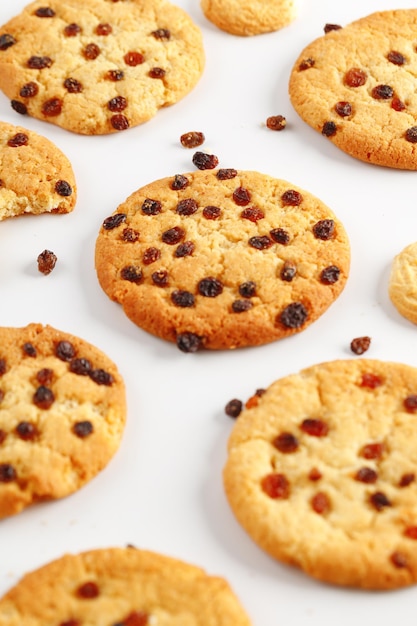 Chocolate american cookies with chocolate chips and raisins on white wooden table Top view flat lay