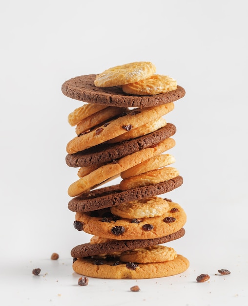 Chocolate american cookies with chocolate chips and raisins on white wooden table Top view flat lay