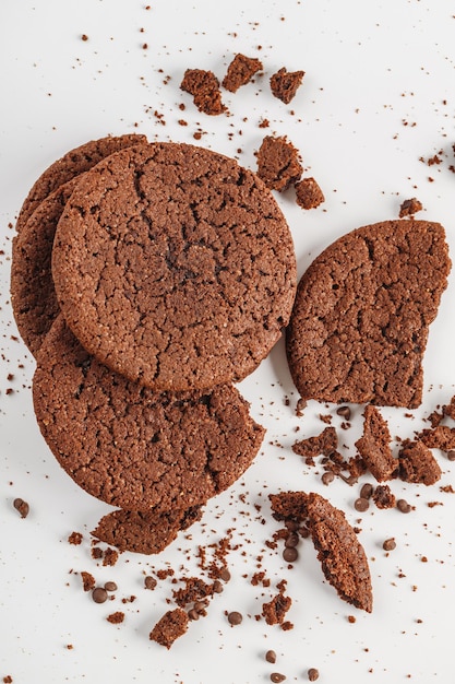 Chocolate american cookies with chocolate chips and raisins on white wooden table Top view flat lay