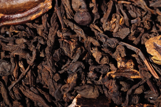 Chocolate black leaf shu puerh tea with cocoa beans closeup macro photography