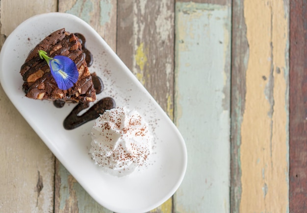 Chocolate Brownie with chocolate sauce and whipping cream Flat lay