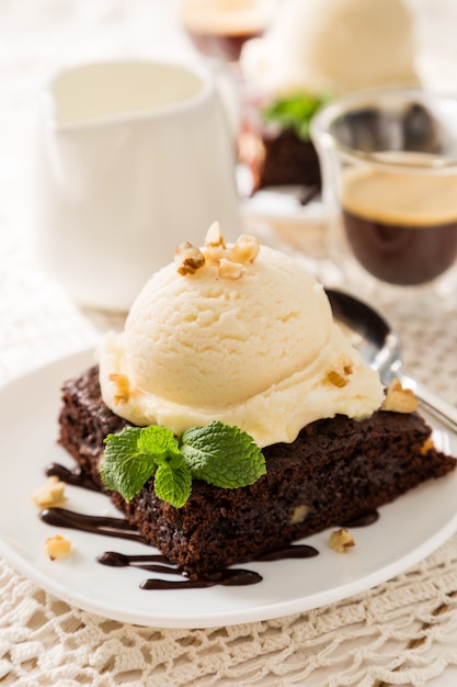 Chocolate brownie with vanilla ice cream, nuts and mint