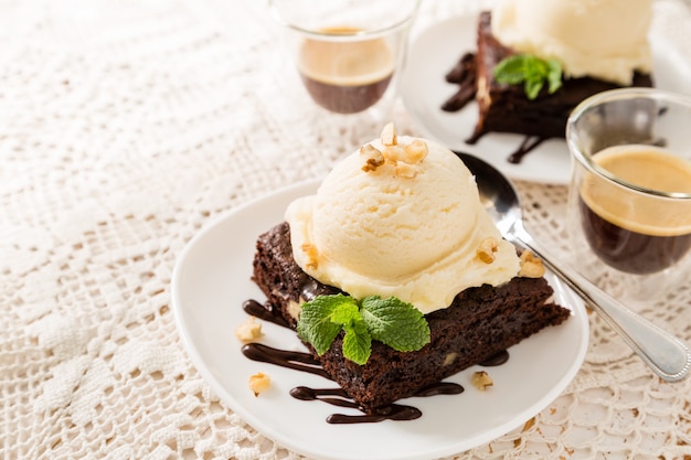 Chocolate brownie with vanilla ice cream, nuts and mint