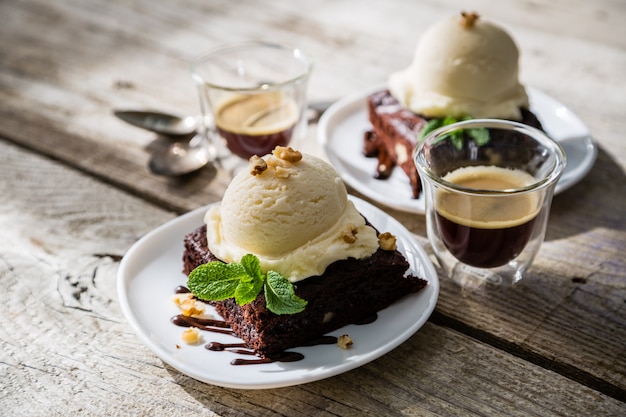 Chocolate brownie with vanilla ice cream, nuts and mint