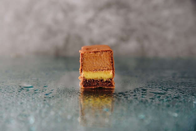 Chocolate cake cut on a mirror surface