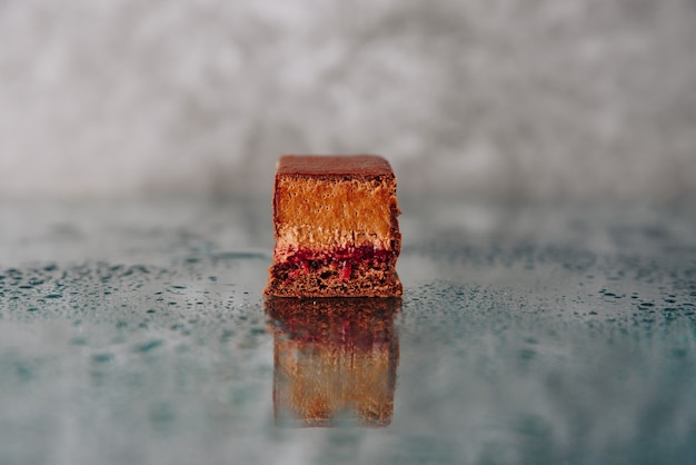 Chocolate cake cut on a mirror surface