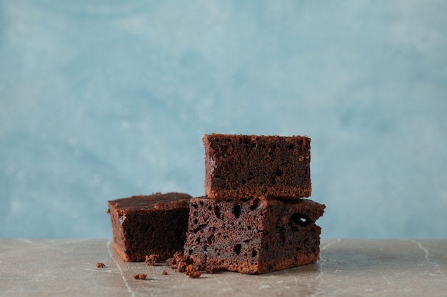 Chocolate cake slice on grey table, space for text