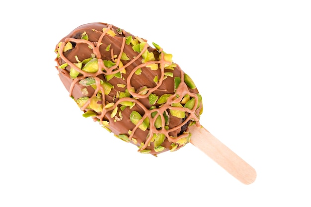 chocolate cake on a stick sprinkled with pistachios isolated