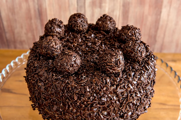 Chocolate cake with brigadeiro grains delicious dessert on a wooden background close up