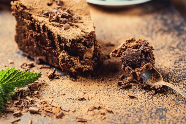 Chocolate cake with CandiesChocolate cake with a cut piece and blade on gray background closeupDark chocolate cakeDelicious vegan chocolate cakeTasty chocolate cake on wooden background