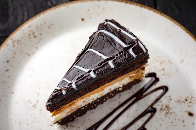 chocolate cake with cream on a wooden background