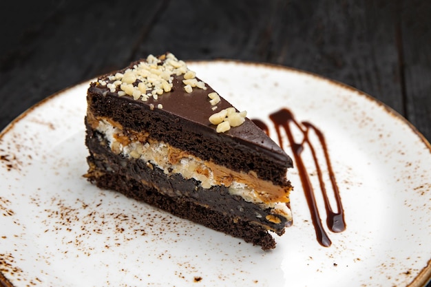 chocolate cake with cream on a wooden background