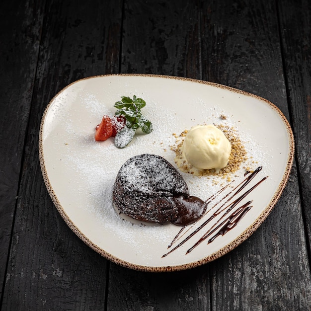 chocolate cake with cream on a wooden background