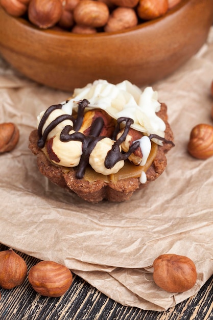 Chocolate cake with nougat and roasted hazelnuts, small cake with hazelnuts and nougat, almonds