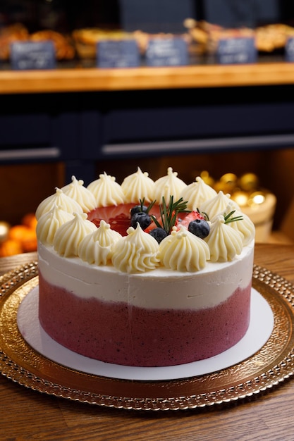 Chocolate cake with whipped cream and fresh berries Closeup with blurred background