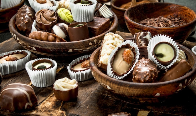 Chocolate candies in a bowls. On a rustic background.