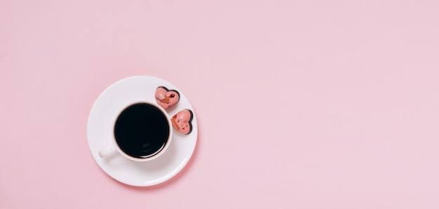 Chocolate candies hearts coffee cup pink background Flat layout copy space Holiday concept February 14 Valentine's Day