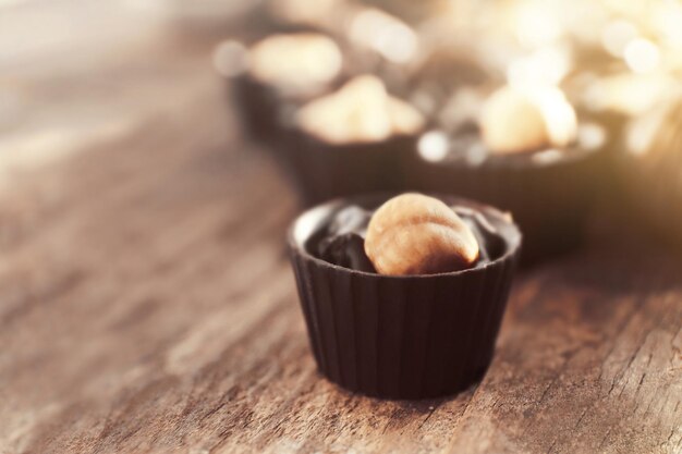 Chocolate candies on wooden background, close up