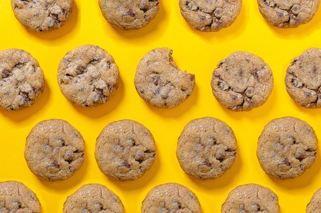 Chocolate chip cookie pattern on yellow background