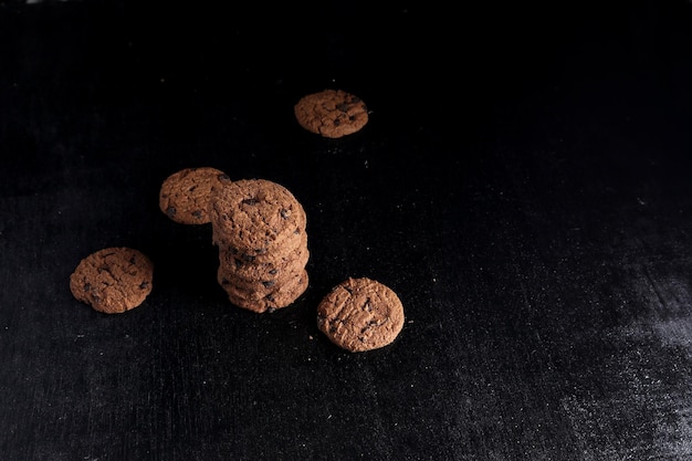 Chocolate chip cookies on black background