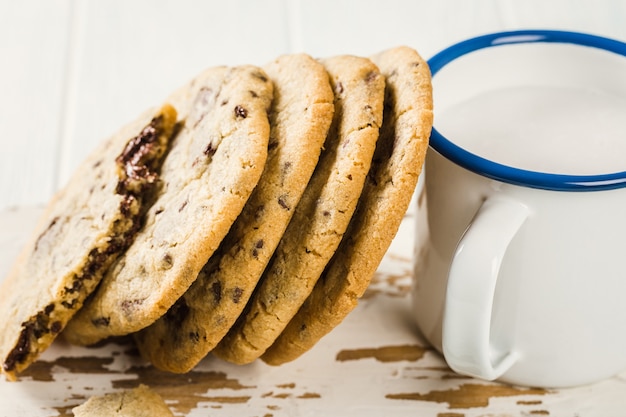 Chocolate chip cookies on old white wooden cutting board. American cuisine