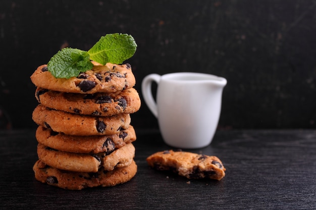 Chocolate chip cookies stack over dark background