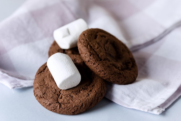 Chocolate Chip and Marshmallow Dark Chocolate Cookies Lying on Pink Napkin Horizontal