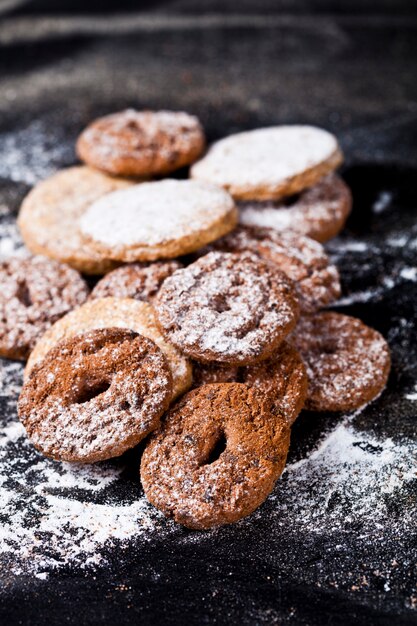 Chocolate chip and oat fresh cookies with sugar powder heap