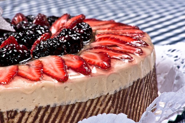 chocolate and coffee cake with strawberries and blackberries with red berries and decorative toppers