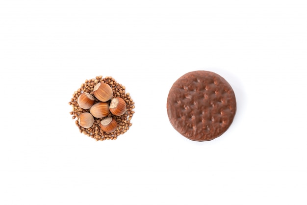 Chocolate cookie with natural healthy cookie made of buckwheat and huzelnuts isolated over white background