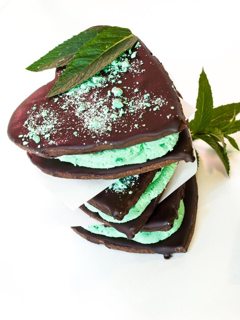 Chocolate cookies with mint filling on white background.