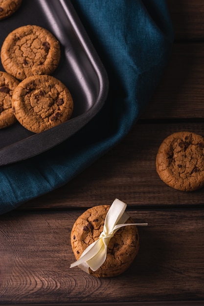 Chocolate cookies on a wooden table decorated with a blue napkin