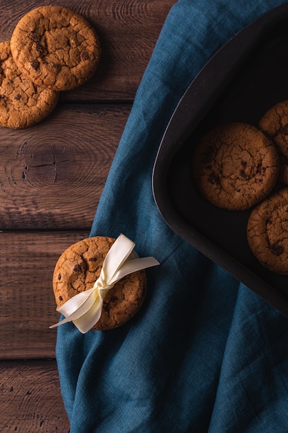 Chocolate cookies on a wooden table decorated with a blue napkin