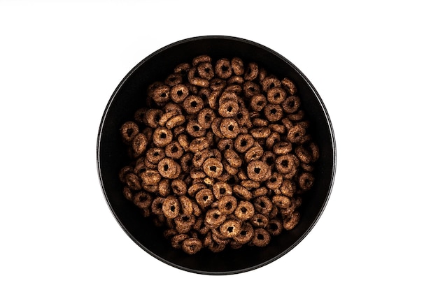 Chocolate corn rings with milk isolated on white background Dry breakfast