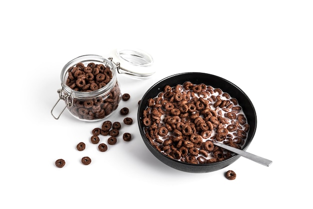 Chocolate corn rings with milk isolated on white background Dry breakfast