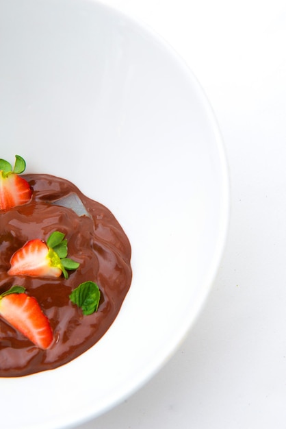 chocolate covered strawberries on a plate on white background