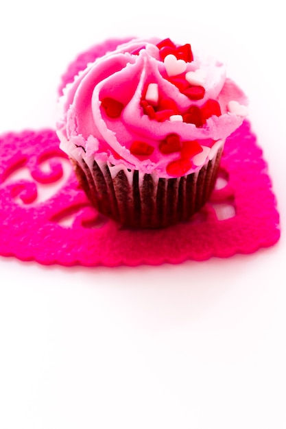 Chocolate cupcake with pink icing decorated for Valentine's Day.