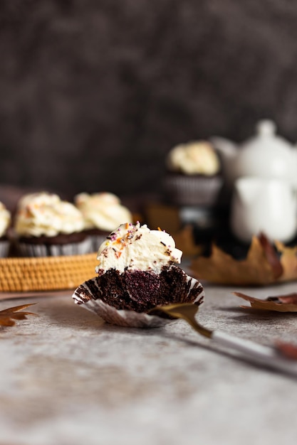 Chocolate cupcakes in a wicker basket One cupcake cut with a fork